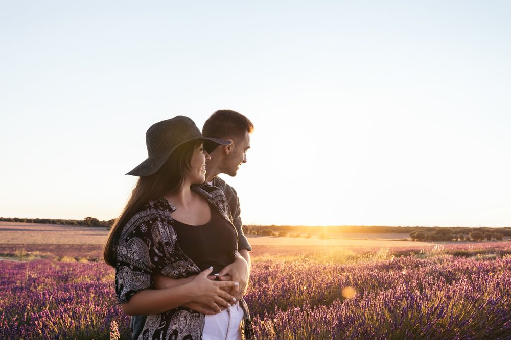 Lovely young couple in a floral field