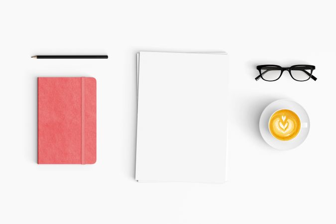 Modern workspace with coffee cup, paper, and notebook copy space