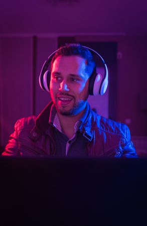 Man listening cheerfully to music with headphones.
