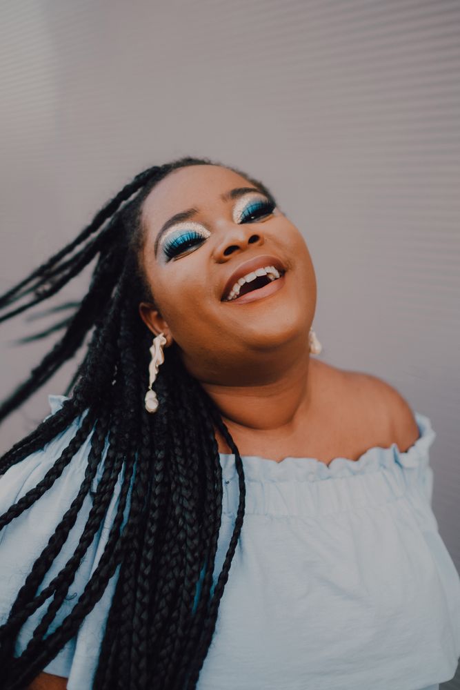 Happy trendy Black woman with flying hair