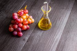 Grapes and oil on table