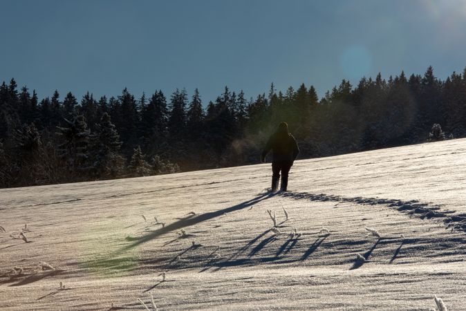 Climbing through deep snow in mountains, on a sunny beautiful day