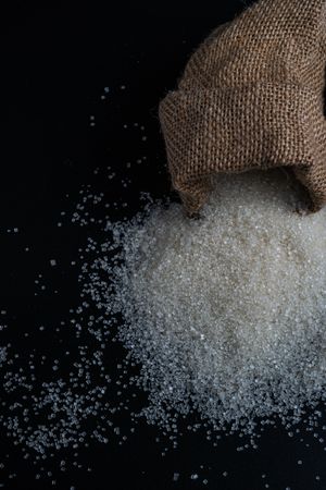 sugar spilling from a burlap sack