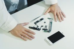 Young man repairing modern device