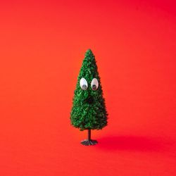 Snowy Christmas tree on red background