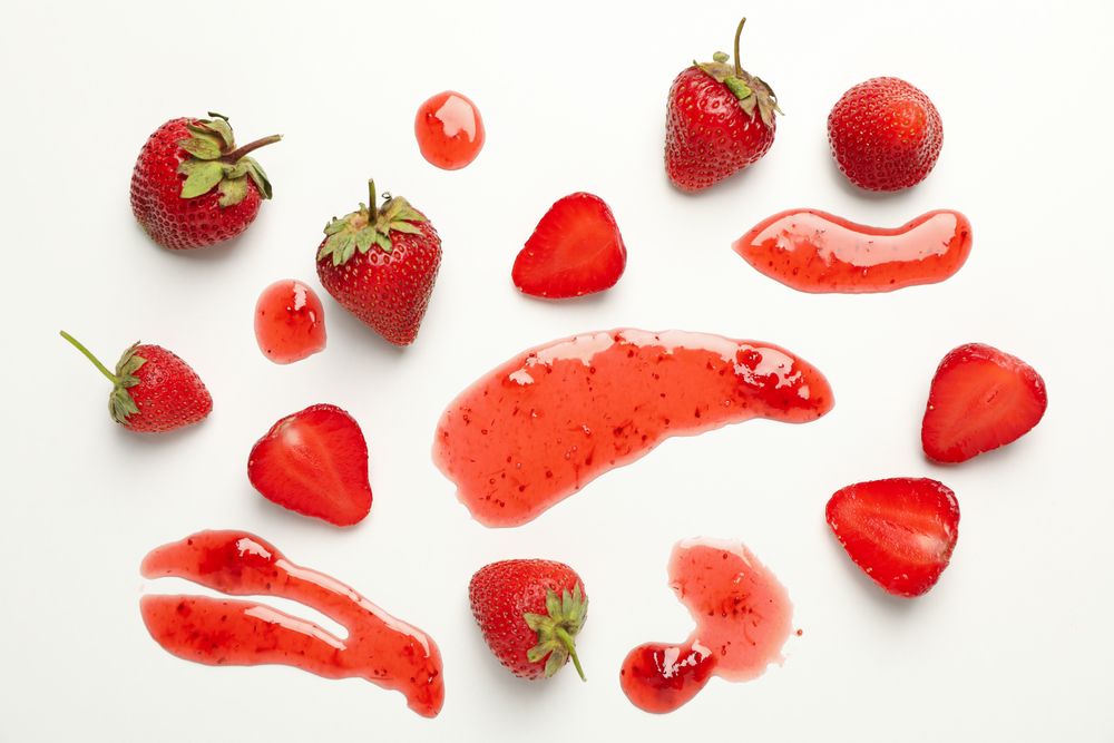 Composition with strawberry and jam on plain background