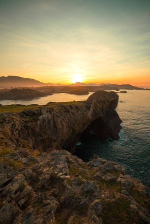 Majestic cliffs of ocean coastline in sunset