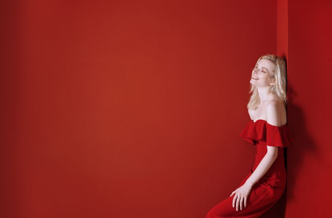 Beautiful young adult woman wearing red jumpsuit