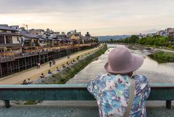 Japan - May, 10 2013: Anonymous person looking at river and town