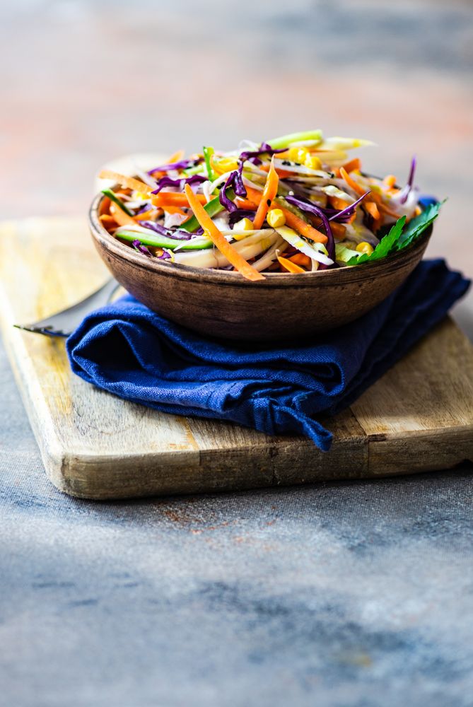 Fresh salad with finely chopped vegetables in bowl with copy space