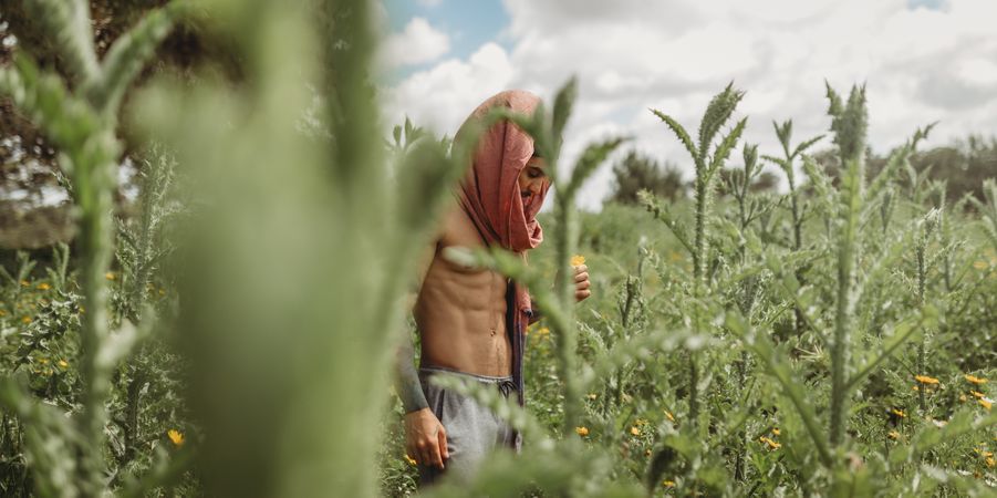 Man training meditating on meadow