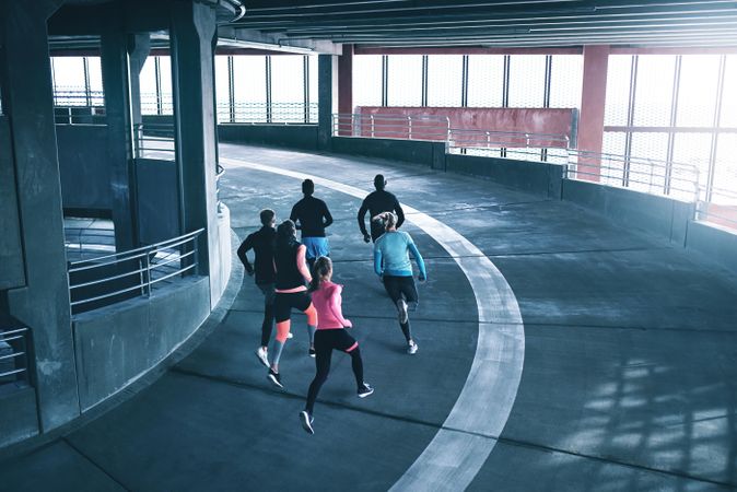 Read shot of multi-ethnic group of people running around the turn