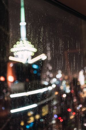 Night city through wet glass