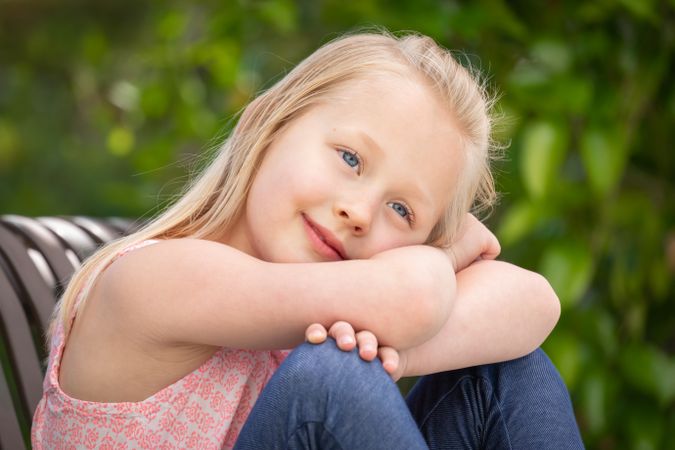 Young Girl Portrait Sitting On The Bench At The Park