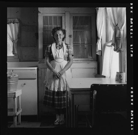 Young mother stands in her kitchen, Utah 1953