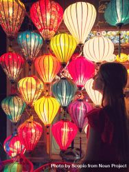Woman looking at colorful lantern 0Jyknb