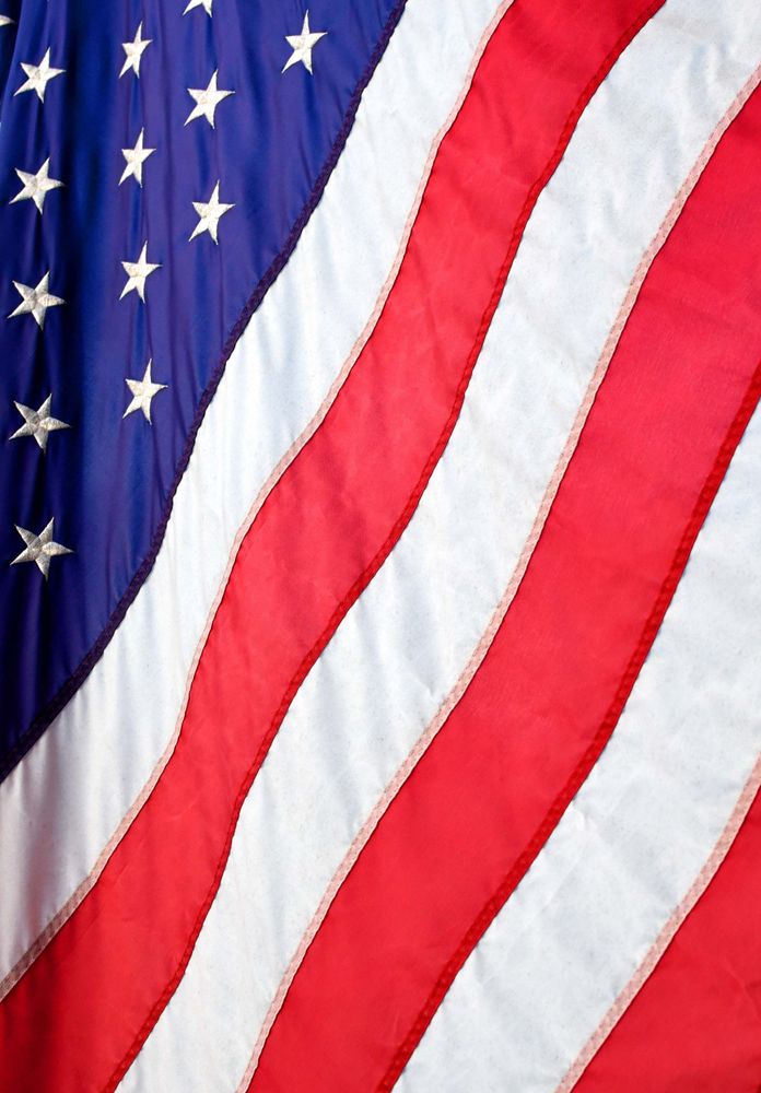 A vertical photo of the USA flag, stars and stripes
