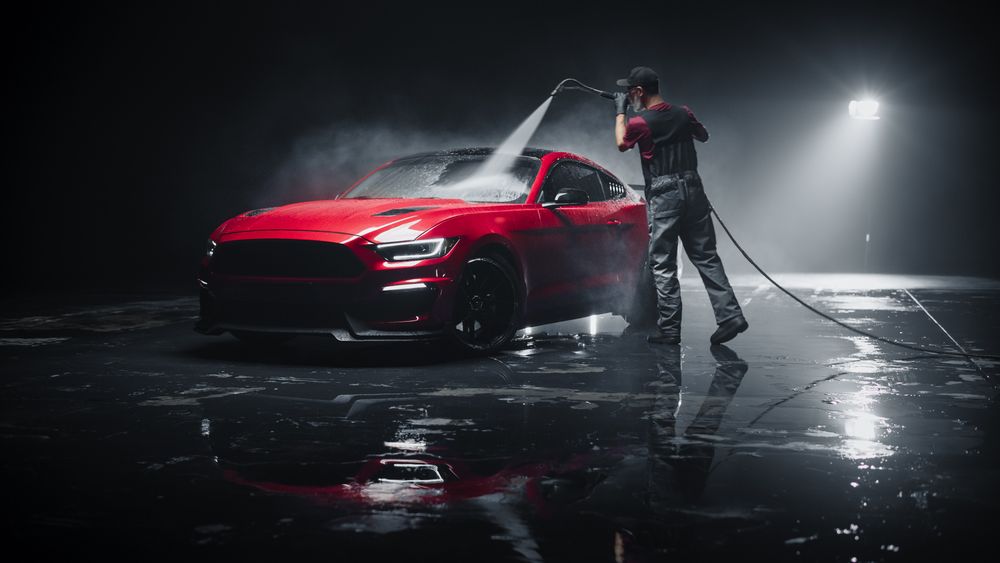 Brand New Sportscar from the Production Line is Being Cleaned with a Water High Pressure Cleaner.