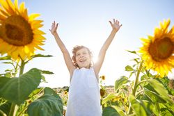 Excited boy on sunflower field