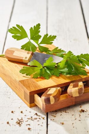 Parsley with knife on cutting board set