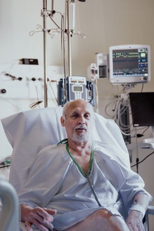 Older man admitted to a hospital room.