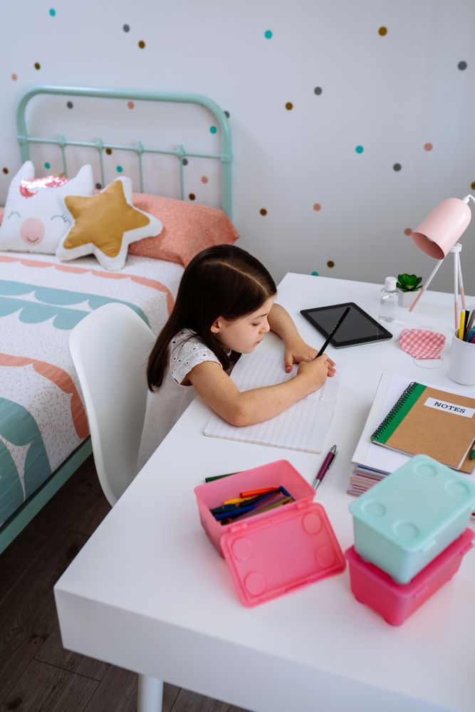 Girl studying at home with mask on table