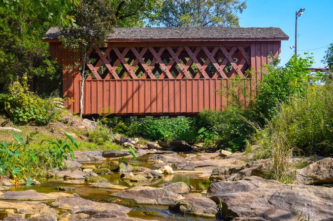 A covered bridge over a stream of running water