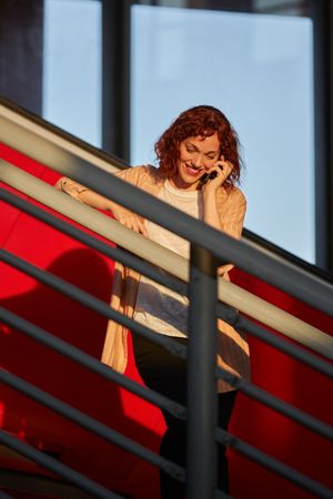 young female communicating via smartphone at station