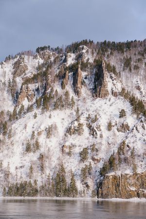 Wide Siberian river and snowy mountains