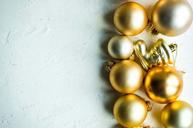 Top view of line of golden Christmas ornaments on table