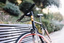 Bike leaning on a bench outdoors in a park