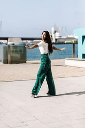 Young woman walking dancing on city street on daylight