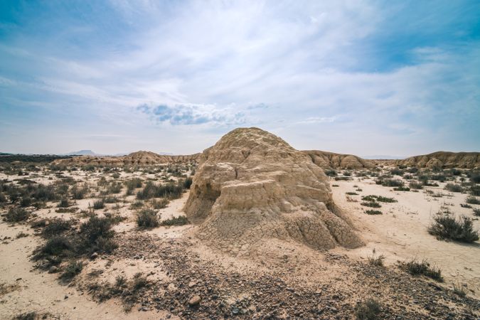 Desert landscape with dry vegetation on background of blue sky