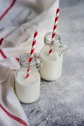 Two bottles of milk on kitchen counter
