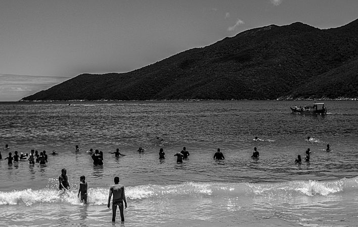 Grayscale photo of people on beach