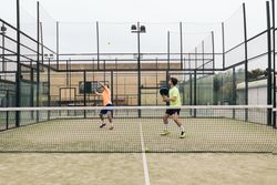 Two young man playing paddle tennis