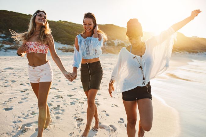 Group of beautiful young women strolling on beach