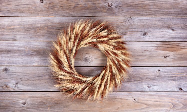 Dried wheat stalk wreath on rustic wood