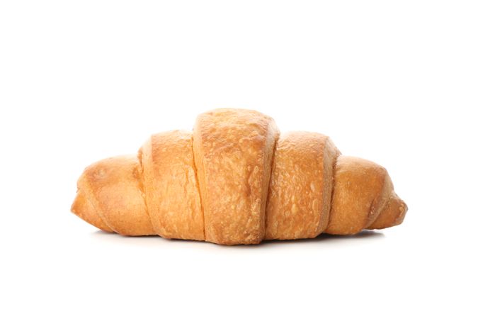 Side view of freshly baked croissant on plain background