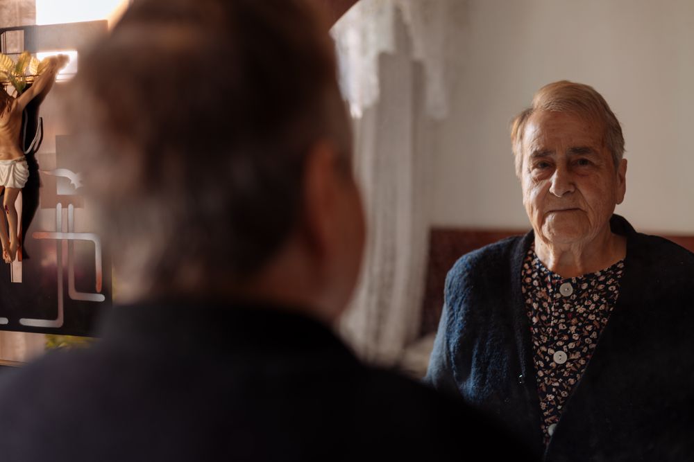 older woman looking in the mirror