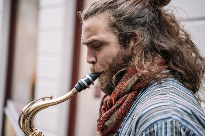 Male saxophonist plays Sax in the street