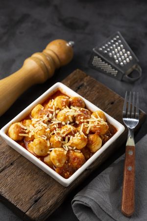 Gnocchi with tomato sauce and grated Parmesan cheese.