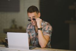 Man working on browsing laptop