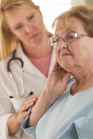 Older Adult Woman Being Consoled by Female Doctor or Nurse