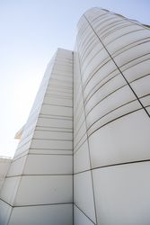 Looking up at windowless facade of modern building