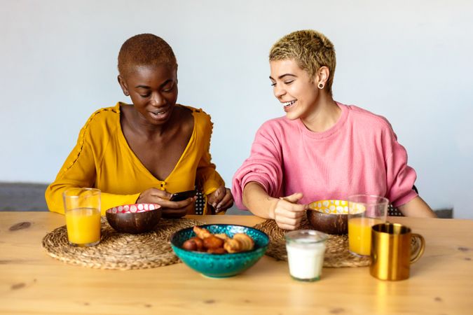 Two multi-ethnic women having breakfast together at home