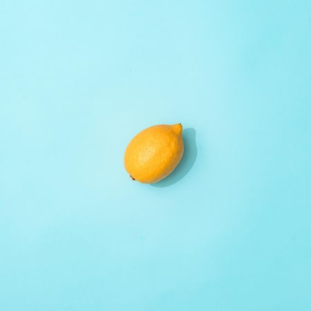 Lemon on pastel blue background
