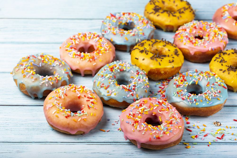Delicious assorted colorful donuts on the table.