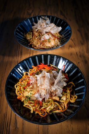Delicious dishes in bowls served on wooden table