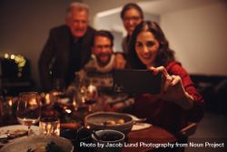 Woman taking selfie with family on christmas eve bedn64